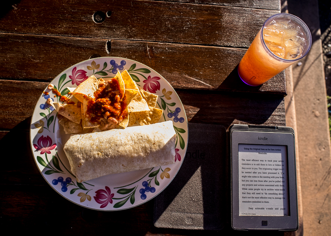 Enjoying a meal with my Kindle